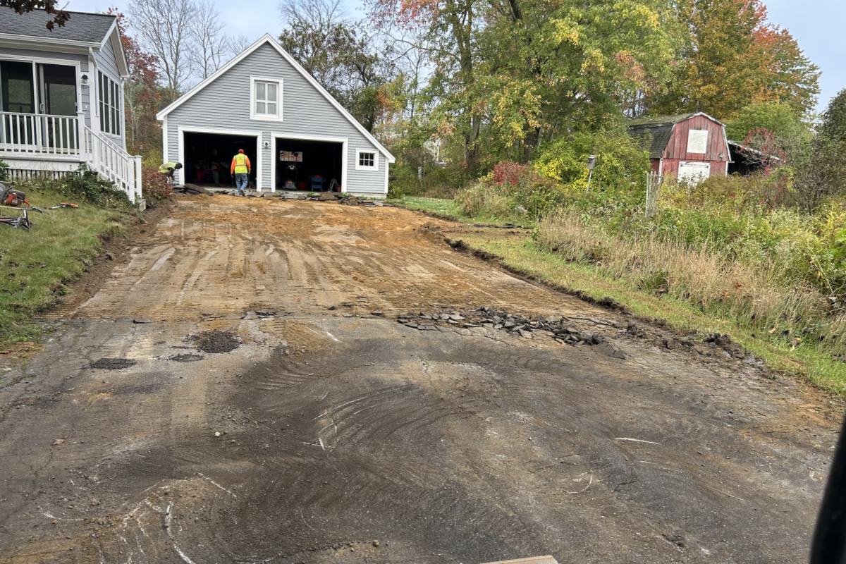 Old asphalt removed and gravel base graded during driveway excavation in Southern Maine